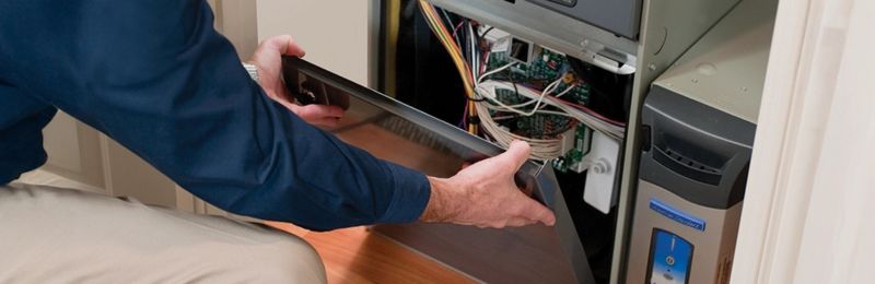 Furnace technician repairing a heating system in National City CA