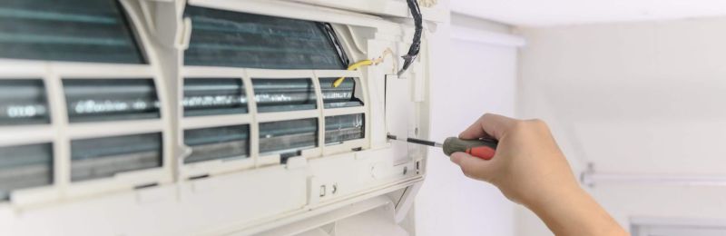 HVAC technician repairing an air conditioner unit in National City CA